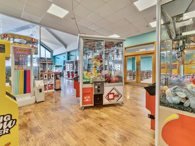 An arcade with claw machines and gumball machines at Wavecrest - Hayling Island Holiday Park
