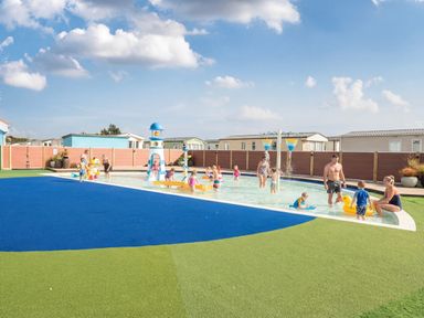 An outdoor pool area with children and adults at Wavecrest - Hayling Island