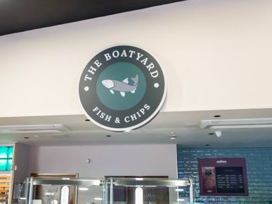 A sign for The Boatyard Fish and Chips inside a building at Billing Aquadrome Holiday Park