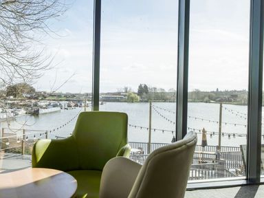 A dining area with a view of the water at Kingfisher Caravan - Billing Aquadrome
