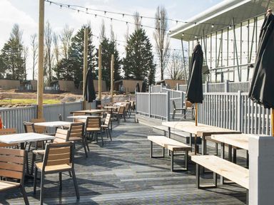 An outdoor seating area with tables and chairs at The Splash Pad - Billing Aquadrome