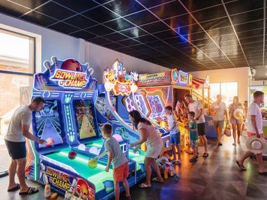 An arcade with bowling and other game machines at Tranquil Waters - Billing Aquadrome