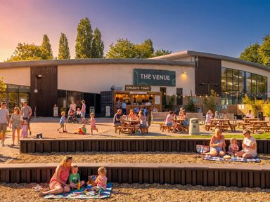 An outdoor dining space with people at The Venue in Billing Aquadrome Holiday Park
