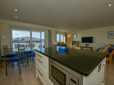 A kitchen and living area with a view at Apartment 12, Burgh Island Causeway Bigbury-On-Sea