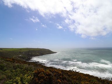 A coastal landscape with cliffs ocean waves and cloudy sky at Springfield in Kingsand