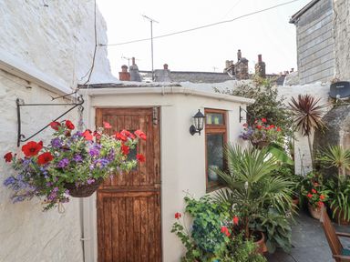 An outdoor area with a door and flowers at Springfield in Kingsand