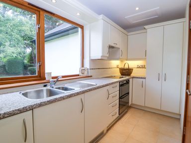 A kitchen with a sink and countertops at Heathcliffe House Caslteton near Cardiff