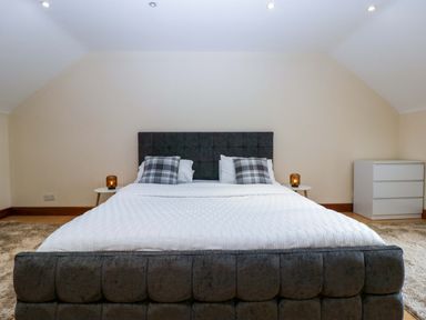 A bedroom with a bed and dresser at Heathcliffe House in Caslteton near Cardiff