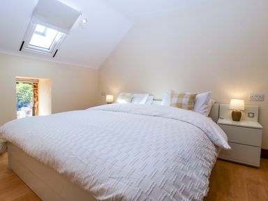 A bedroom with a bed and a window at Heathcliffe House Caslteton near Cardiff
