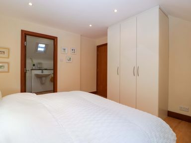 A bedroom with a bed and wardrobe at Heathcliffe House Caslteton near Cardiff