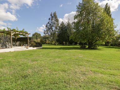 A garden with grass and trees at Heathcliffe House in Castleton near Cardiff