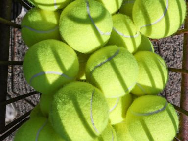 A collection of tennis balls stacked on a metal rack at Heathcliffe House in Castleton near Cardiff