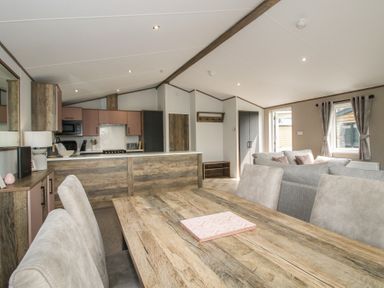 A dining area and kitchen with seating at Peony in Eardisland