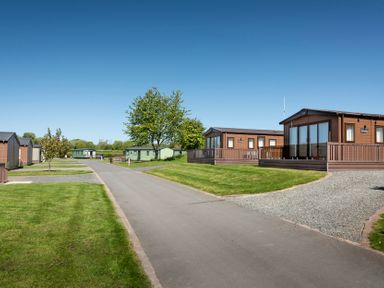 An outdoor area with cabins and a road at Peony in Eardisland
