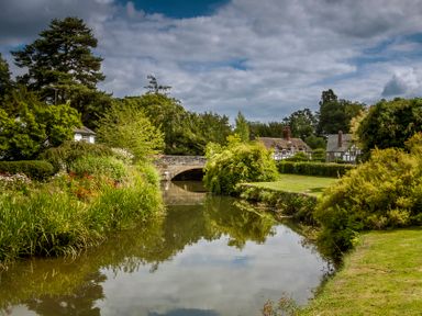 A scenic view with a bridge over water at Peony in Eardisland