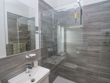 A bathroom with a sink mirror shower area and towel at Swifts Reach Lodge Kirkstone 10 Limefitt Park near Windermere