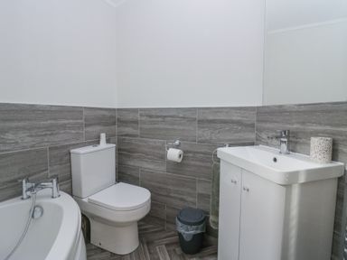 A bathroom with a toilet sink and bathtub at Swifts Reach Lodge in Kirkstone 10 Limefitt Park near Windermere
