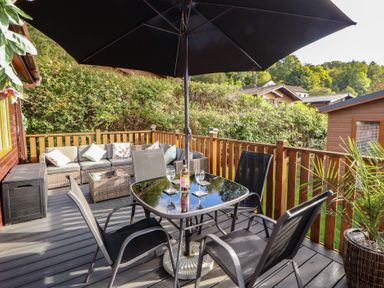 An outdoor patio area with a table and chairs at Swifts Reach Lodge, Kirkstone 10, Limefitt Park near Windermere