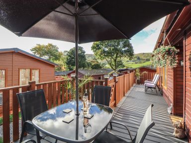 An outdoor area with a table and chairs at Swifts Reach Lodge, Kirkstone 10, Limefitt Park near Windermere