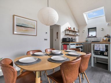 A dining room with a table set for six at Grove Cottage in Kington