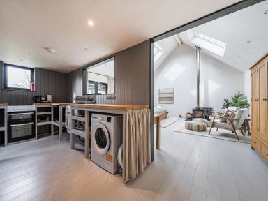 A kitchen with a washing machine and stove at Grove Cottage Kington