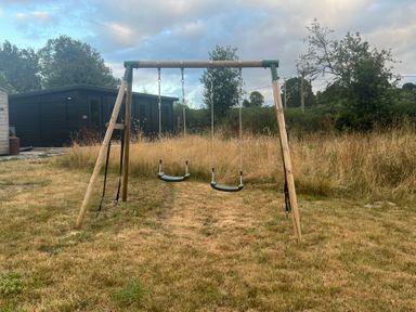 A swing set in a garden at Grove Cottage in Gladestry