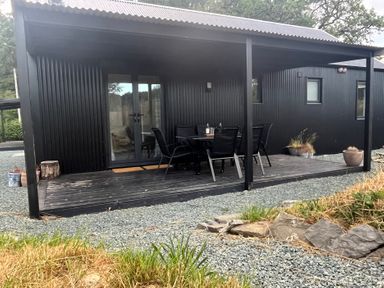 An outdoor seating area with a table and chairs at Grove Cottage in Gladestry