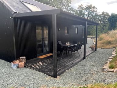 An outdoor area with a table and chairs at Grove Cottage in Gladestry