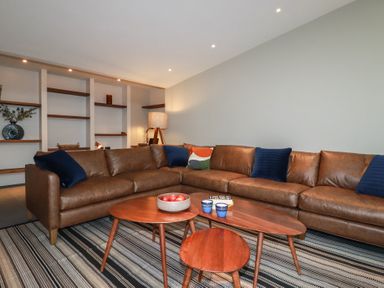 A living room with a sofa and a coffee table at Harberton