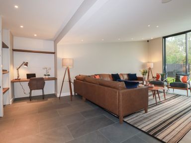 A living room with a sofa and desk at Harberton 
