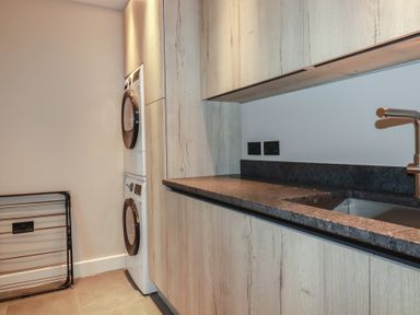 A laundry room with a washer and dryer at Harberton