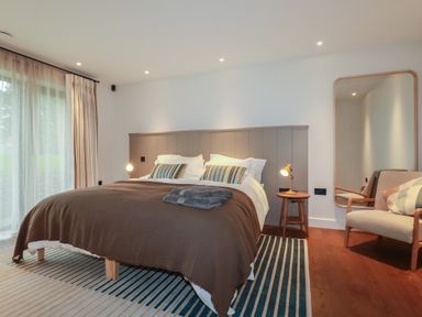A bedroom with a bed and a chair at Harberton