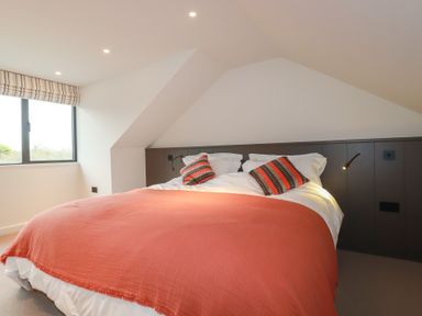 A bedroom with a bed and window at Harberton