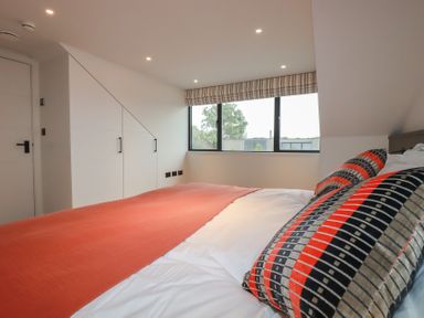A bedroom with a bed and wardrobe at Harberton