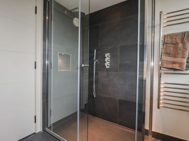 A shower with glass enclosure at Harberton