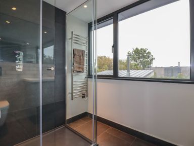 A bathroom with a shower and towel rail at Harberton