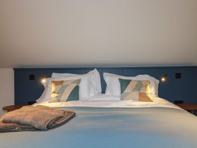 A bedroom with a bed and pillows at Harberton