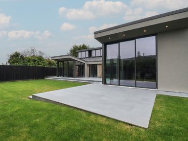 An outdoor area with two houses and a grass lawn at Harberton
