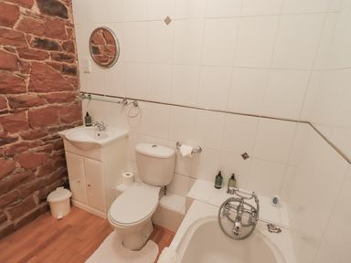 A bathroom with a sink, toilet, and bathtub at The Hayloft near Wigton