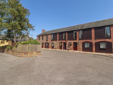 An exterior view of buildings with windows and doors at The Coach House near Wigton