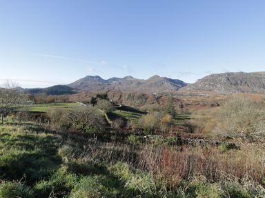 A landscape with mountains and trees at Waterfall Retreat in Blaenau Ffestiniog