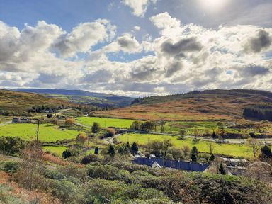 A landscape view of fields and hills at Waterfall Retreat in Blaenau Ffestiniog