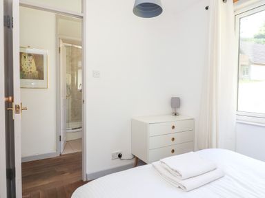 A bedroom with a bed and a chest of drawers at Valley Lodge 37, St Ann's Chapel, Cornwall