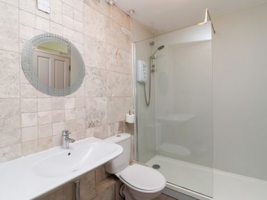 A bathroom with a sink, toilet, and shower at Valley Lodge 37 in St Ann's Chapel, Cornwall