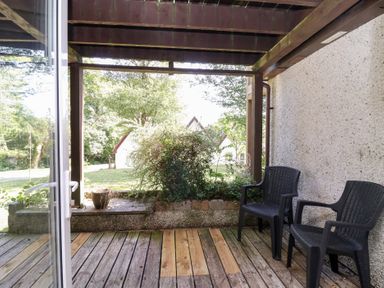 An outdoor area with chairs and plants at Valley Lodge 37 St Ann's Chapel, Cornwall