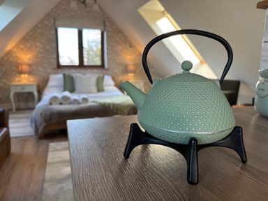 A kettle on a table in a bedroom at Pheasants Rise Apartment in Ross-On-Wye