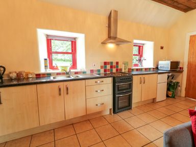 A kitchen with countertops and appliances at Shane's Cottage in Falcarragh, County Donegal