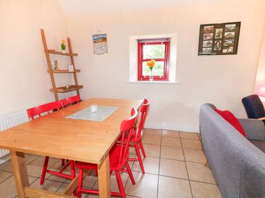 A dining room with a table and chairs at Shane's Cottage in Falcarragh, County Donegal