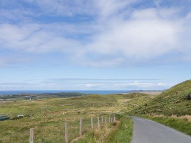A landscape view with a road and grass hills at Shane's Cottage, Falcarragh, County Donegal