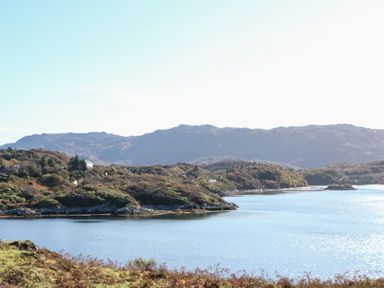 A coastal landscape with water and hills in the background at Creag Mhor Lodge Back of Keppoch near Arisaig